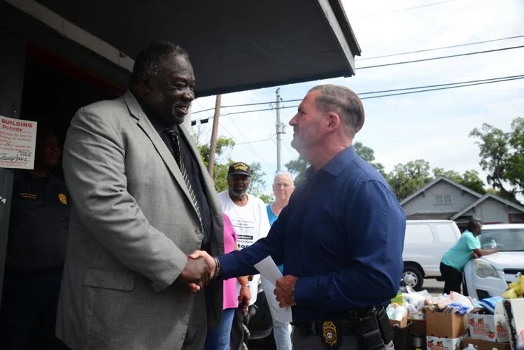 Dr. Leonard Small of Litway Missionary Baptist Church, Savannah Georgia shakes hands with Brunswick Police Chief Kevin Jones